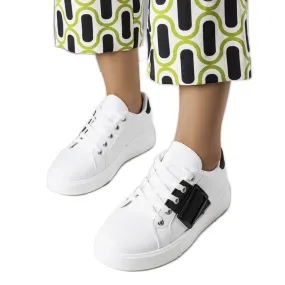 White sneakers decorated with a black Erin buckle